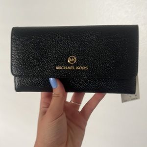 Micheal Kors Wallet. Never been used. Tag attached. Black leather.